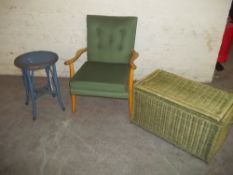 A FIRESIDE CHAIR, A WICKER OTTOMAN AND A LOOM SIDE TABLE