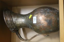 AN ANTIQUE PERSIAN DECORATED COPPER EWER JUG