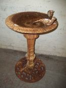 AN ANTIQUE CAST IRON BIRDBATH