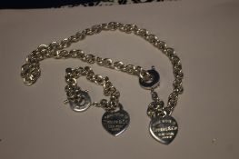 A SILVER NECKLACE AND BRACELET WITH HEART PENDANTS