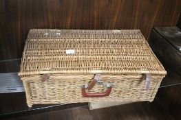 A LARGE WICKER CASED PICNIC SET