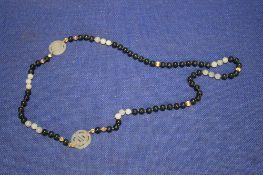A CHINESE JADE TYPE BEAD NECKLACE WITH 2 CHARACTER PANELS