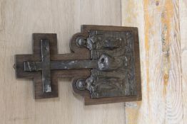 A CAST METAL RELIGIOUS SCENE MOUNTED ON A WOODEN PLAQUE