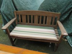 A WOODEN GARDEN BENCH