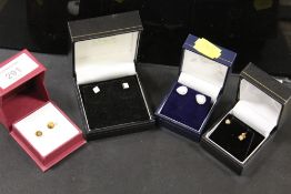 A PAIR OF TIGERS EYE SET STUD EARRINGS TOGETHER WITH TWO PAIRS OF SILVER EARRINGS AND A PAIR OF STUD