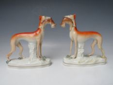 A PAIR OF 19TH CENTURY STAFFORDSHIRE GREYHOUNDS WITH HARES IN THEIR MOUTHS, H 19 cm (2)