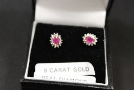 A PAIR OF A RUBY AND DIAMOND SET EARRINGS