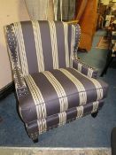A MODERN STRIPED UPHOLSTERED ARMCHAIR