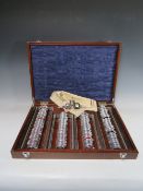 A LARGE OPTICIANS TRIAL LENS SET WITH CLEMENT CLARKE HOLDER, in mahogany case