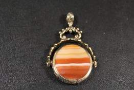 A SWIVEL BANDED AGATE FOB IN ORNATE YELLOW METAL MOUNT