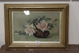 A FRAMED AND GLAZED STILL LIFE STUDY OF ROSES ON A TABLE, INDISTINCTLY SIGNED LOWER RIGHT