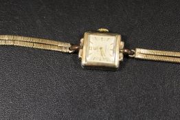 A LADIES CYMA CYMAFLEX LADIES WRIST WATCH ON A HALLMARKED 9CT GOLD TWO STRAND SNAKE LINK BRACELET