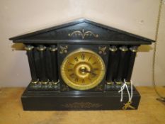 AN ANTIQUE BLACK SLATE MANTLE CLOCK