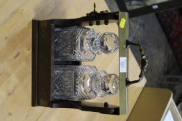 A TWO BOTTLE TANTALUS WITH MATCHED GLASS DECANTERS