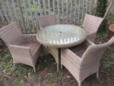 A MODERN CIRCULAR RATTAN PATIO TABLE AND FOUR CHAIRS