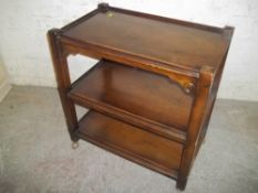 A SOLID OAK CAKE SERVING TROLLEY