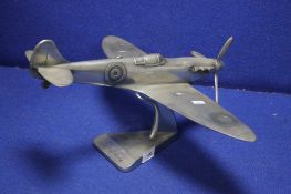 A WHITE METAL MODEL OF A SPIT FIRE