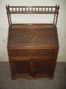 AN ANTIQUE BUREAU WITH GALLERY SHELF AND CHIPPENDALE LATTICE STYLE DESIGN