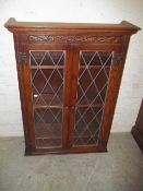 AN OAK LEADED OLD CHARM GLAZER BOOKCASE