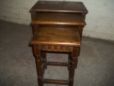 A SOLID OAK NEST OF TABLES
