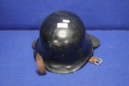 A VINTAGE MILITARY TYPE HELMET