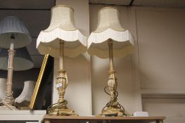 A PAIR OF ORNATE TABLE LAMPS WITH CREAM LAMP SHADES