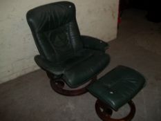 A STRESSLESS EKORNES SWIVEL RECLINER AND STOOL