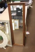 AN OBLONG FRAMED MIRROR