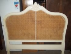 A LARGE RATTAN FLOORSTANDING HEADBOARD