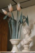 A CERAMIC BUST TOGETHER WITH A FLOWER ARRANGEMENT