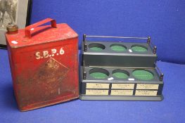 AN ANTIQUE BP FUEL CAN TOGETHER WITH A BOTTLE HOLDER