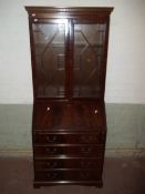 A REPRODUCTION LEATHER INLAID BUREAU BOOKCASE