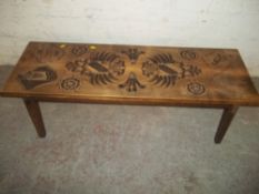 A CARVED CRESTED COFFEE TABLE