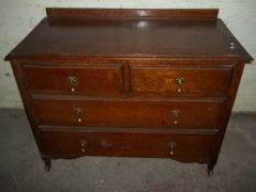 AN OAK MID CENTURY CHEST OF DRAWERS