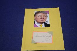 A MOUNTED DONALD TRUMP SIGNED PHOTOGRAPH, and a signed Dennis Skinner Card