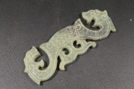 AN EARLY CHINESE JADE PLAQUE WITH DRAGON DESIGN
