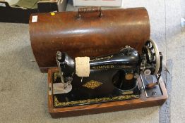 A VINTAGE CASED SINGER SEWING MACHINE