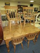 A FARMHOUSE STYLE PINE TABLE AND SIX CHAIRS