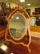 A LATE 19TH CENTURY MAHOGANY DRESSING MIRROR, the oval mirror supported on a shaped framed, H 76 cm