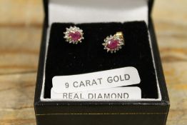 A PAIR OF A RUBY AND DIAMOND SET EARRINGS