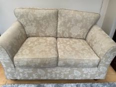 A CREAM M & S TWO SEATER SOFA