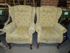 A PAIR OF MODERN UPHOLSTERED WINGBACK ARMCHAIRS