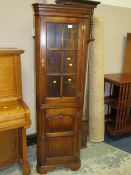A SMALL REPRODUCTION OAK GLAZED FLOORSTANDING CORNER CABINET