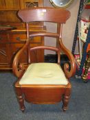 AN ANTIQUE MAHOGANY COMMODE ARMCHAIR