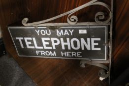 A VINTAGE WALL MOUNTED DOUBLE SIDED TELEPHONE SIGN