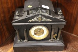 A FRENCH BLACK SLATE MANTLE CLOCK OF ARCHITECTURAL FORM