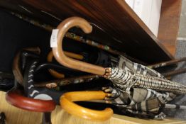 A COLLECTION OF WALKING STICKS & UMBRELLAS ETC