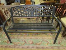 A MODERN METAL GARDEN BENCH