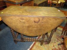 AN ANTIQUE OAK BOBBIN LEG DROPLEAF TABLE
