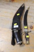 A VINTAGE KUKRI IN SCABBARD (MISSING SMALLER DAGGER) TOGETHER WITH A SMALL DAGGER IN SCABBARD